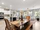 Open-concept living space featuring a modern kitchen, dining area, and comfortable lounge with abundant natural light at 7476 Opal Star St, North Las Vegas, NV 89084
