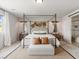 Spacious main bedroom featuring a four-poster bed, decorative pillows, and modern furnishings at 7476 Opal Star St, North Las Vegas, NV 89084