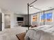 This primary bedroom has lots of open area and natural lighting with a door to the primary bath at 7476 Opal Star St, North Las Vegas, NV 89084
