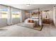 This main bedroom features a spacious layout, large windows, and a four-poster bed at 7476 Opal Star St, North Las Vegas, NV 89084
