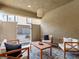 Comfortable outdoor patio setting with a wooden table, cozy seating, and a view of the gated entrance at 7476 Opal Star St, North Las Vegas, NV 89084