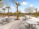 Scenic community picnic area featuring modern tables surrounded by mature landscaping and trees at 7476 Opal Star St, North Las Vegas, NV 89084