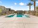 A community pool offers a refreshing escape, framed by palm trees and secure fencing, perfect for relaxation at 7476 Opal Star St, North Las Vegas, NV 89084