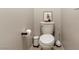 This modern powder room features a classic white toilet and minimalistic decorations at 7476 Opal Star St, North Las Vegas, NV 89084