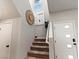 Well-lit staircase with carpeted steps, white walls, decorative accents, and access to the upper level at 7476 Opal Star St, North Las Vegas, NV 89084