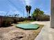 Expansive backyard featuring palm trees and a unique green platform at 8072 Hackberry Dr, Las Vegas, NV 89123