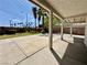 Covered patio area overlooking the large backyard with palm trees at 8072 Hackberry Dr, Las Vegas, NV 89123