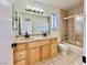 Bathroom features a double sink vanity and shower with gold trim at 8072 Hackberry Dr, Las Vegas, NV 89123