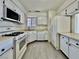 Compact kitchen featuring white appliances and laminate flooring at 8072 Hackberry Dr, Las Vegas, NV 89123