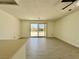 Open living area with neutral walls and wood laminate flooring leading to a backyard patio at 8072 Hackberry Dr, Las Vegas, NV 89123