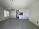 Open living area with neutral walls and wood laminate flooring leading to the kitchen at 8072 Hackberry Dr, Las Vegas, NV 89123