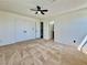 Main bedroom features a ceiling fan, carpet, and two doors at 8072 Hackberry Dr, Las Vegas, NV 89123