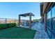 Backyard with outdoor kitchen, artificial turf and landscaping at 818 Laceleaf St, Las Vegas, NV 89138