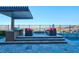 Outdoor kitchen area with grill, lush seating and desert views at 818 Laceleaf St, Las Vegas, NV 89138