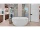 Bright bathroom featuring standalone tub, dual vanity, and walk-in shower at 818 Laceleaf St, Las Vegas, NV 89138