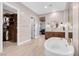 Bright bathroom with a standalone tub, wood cabinets, and a walk-in closet at 818 Laceleaf St, Las Vegas, NV 89138