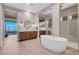 Bright bathroom with modern wood cabinets, standalone tub and walk-in shower at 818 Laceleaf St, Las Vegas, NV 89138