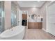 Bright bathroom featuring a soaking tub, a walk-in shower, and a modern vanity at 818 Laceleaf St, Las Vegas, NV 89138