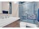 Bright bathroom featuring blue tiled walk-in shower, modern vanity and beautiful fixtures at 818 Laceleaf St, Las Vegas, NV 89138