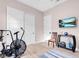 Light and bright exercise room with sleek bike and flat screen TV at 818 Laceleaf St, Las Vegas, NV 89138