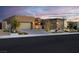 Beautiful front exterior showcasing a landscaped yard, brick driveway, and built-in garage at 818 Laceleaf St, Las Vegas, NV 89138