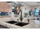 Close-up of the kitchen island featuring a modern faucet, granite countertops, and ample space at 818 Laceleaf St, Las Vegas, NV 89138