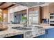Close-up of cooktop in modern kitchen with granite countertop and stainless steel appliances at 818 Laceleaf St, Las Vegas, NV 89138