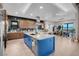 Open-concept kitchen with a large center island, stainless steel appliances, and adjacent dining area at 818 Laceleaf St, Las Vegas, NV 89138