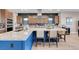Stylish kitchen featuring a large island with seating, stainless steel range hood, and ample counter space at 818 Laceleaf St, Las Vegas, NV 89138
