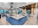 Large kitchen island with a cooktop, sink, and ample space connecting to an open floorplan with dining at 818 Laceleaf St, Las Vegas, NV 89138