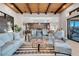 Spacious living room with wood beam ceiling, plush seating, and view into the modern kitchen at 818 Laceleaf St, Las Vegas, NV 89138