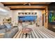 Stylish living room with wood beam ceiling, modern fireplace, and sliding doors to the outdoor space at 818 Laceleaf St, Las Vegas, NV 89138