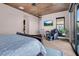 Well-lit main bedroom with wood ceiling, patio access, and relaxing massage chair at 818 Laceleaf St, Las Vegas, NV 89138