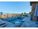 The backyard includes a pool, jacuzzi and seating at 818 Laceleaf St, Las Vegas, NV 89138