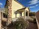 Backyard view showcasing the covered patio, tropical plants, and serene outdoor living space at 8205 Celina Hills St, Las Vegas, NV 89131