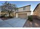 Two-story home with an attached garage and neutral-toned stucco exterior, showcasing curb appeal at 8205 Celina Hills St, Las Vegas, NV 89131