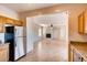 Open layout showing kitchen with stainless steel refrigerator that flows into the adjacent living room at 8205 Celina Hills St, Las Vegas, NV 89131