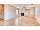 Spacious living room with tile flooring, fireplace, ceiling fan, and natural light from two windows at 8205 Celina Hills St, Las Vegas, NV 89131