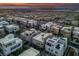 An aerial view of a residential community showcasing modern homes, neatly arranged streets, and a scenic cityscape at 845 Loch Katrine Ave, Henderson, NV 89012