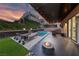 Outdoor living area with a covered patio, a swimming pool, lounge chairs, and privacy landscaping at 845 Loch Katrine Ave, Henderson, NV 89012