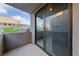 This outdoor balcony features textured walls and an enclosed sliding glass door to an indoor living space at 845 Loch Katrine Ave, Henderson, NV 89012