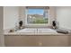 A luxurious soaking tub overlooking serene mountain views provides a spa-like experience at 845 Loch Katrine Ave, Henderson, NV 89012