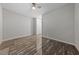 Neutral bedroom with ceiling fan and marble-look tile floors, door to hallway and closet at 845 Loch Katrine Ave, Henderson, NV 89012