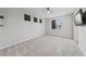 Bright bedroom with large windows, a ceiling fan and soft carpeted floors with light-colored walls at 845 Loch Katrine Ave, Henderson, NV 89012