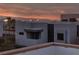 Exterior view showcasing a modern home design with mountain and city views as well as a colorful sunset sky at 845 Loch Katrine Ave, Henderson, NV 89012