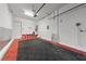 Spacious garage with red and black checkered flooring, overhead lighting, and an automatic door opener at 845 Loch Katrine Ave, Henderson, NV 89012