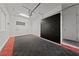 Clean garage with storage cabinets and checkered flooring, with overhead lighting and an automatic door opener at 845 Loch Katrine Ave, Henderson, NV 89012