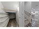 Hallway with storage, shelving and staircase with railing leading into the kitchen at 845 Loch Katrine Ave, Henderson, NV 89012