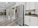Bright kitchen featuring stainless steel refrigerator, and modern cabinetry with stylish flooring at 845 Loch Katrine Ave, Henderson, NV 89012