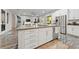 A gourmet kitchen with stainless steel appliances, spacious island and modern cabinetry in neutral colors at 845 Loch Katrine Ave, Henderson, NV 89012